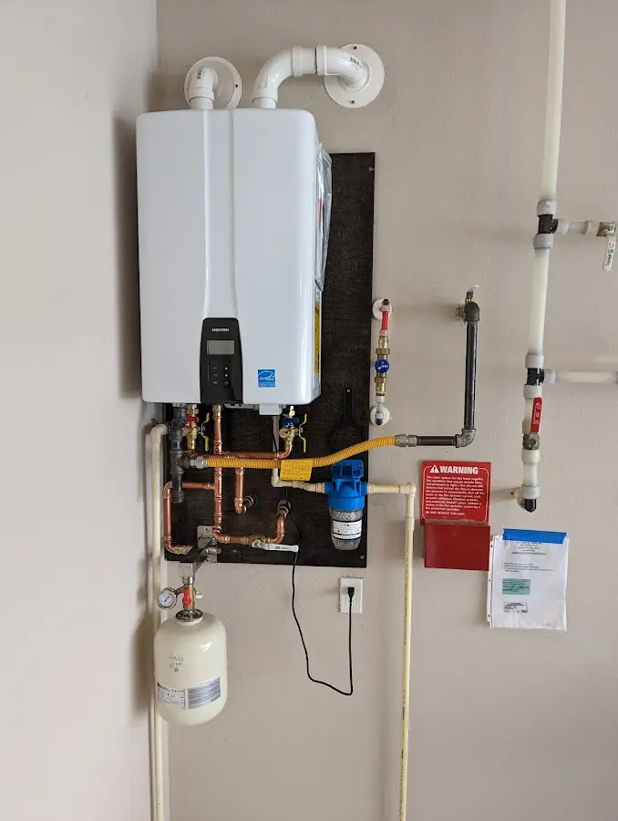 Professional plumber installing copper piping in a Rose Hill home